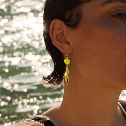 Deco Mosaic 18K gold-plated lime green enamel hook drop earring worn as a close-up lifestyle shot against a sparkling water background — Studio Anivarya