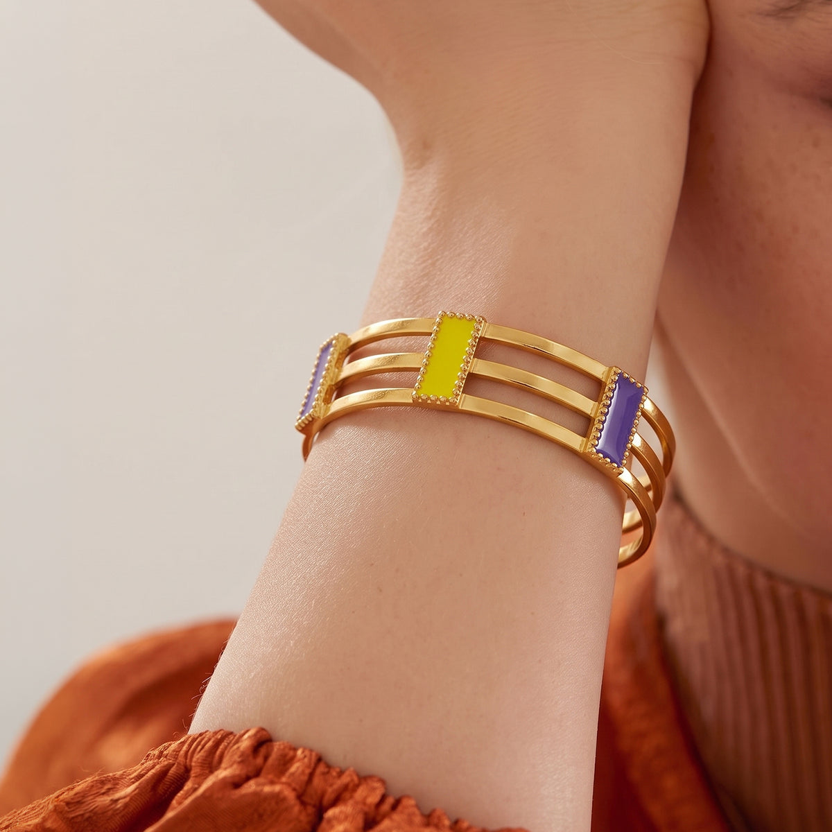 Deco Mosaic 18K gold-plated cuff bracelet in lilac and citrus yellow enamel worn with burnt orange casual outfit — model shot — Studio Anivarya