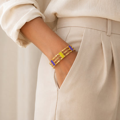 Deco Mosaic 18K gold-plated cuff bracelet in lilac and citrus yellow enamel worn with ivory workwear — model shot — Studio Anivarya
