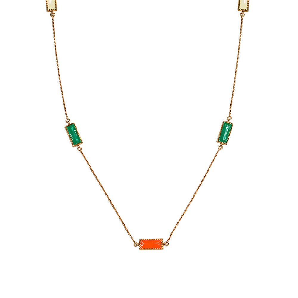 Close-up of Deco Mosaic 18K gold-plated rectangular enamel pendant necklace showing white, orange and green resin enamel detail on white background — Studio Anivarya