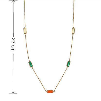 Close-up of Deco Mosaic 18K gold-plated rectangular enamel pendant necklace in ivory, orange and green showing 23 cm closed length from nape — Studio Anivarya