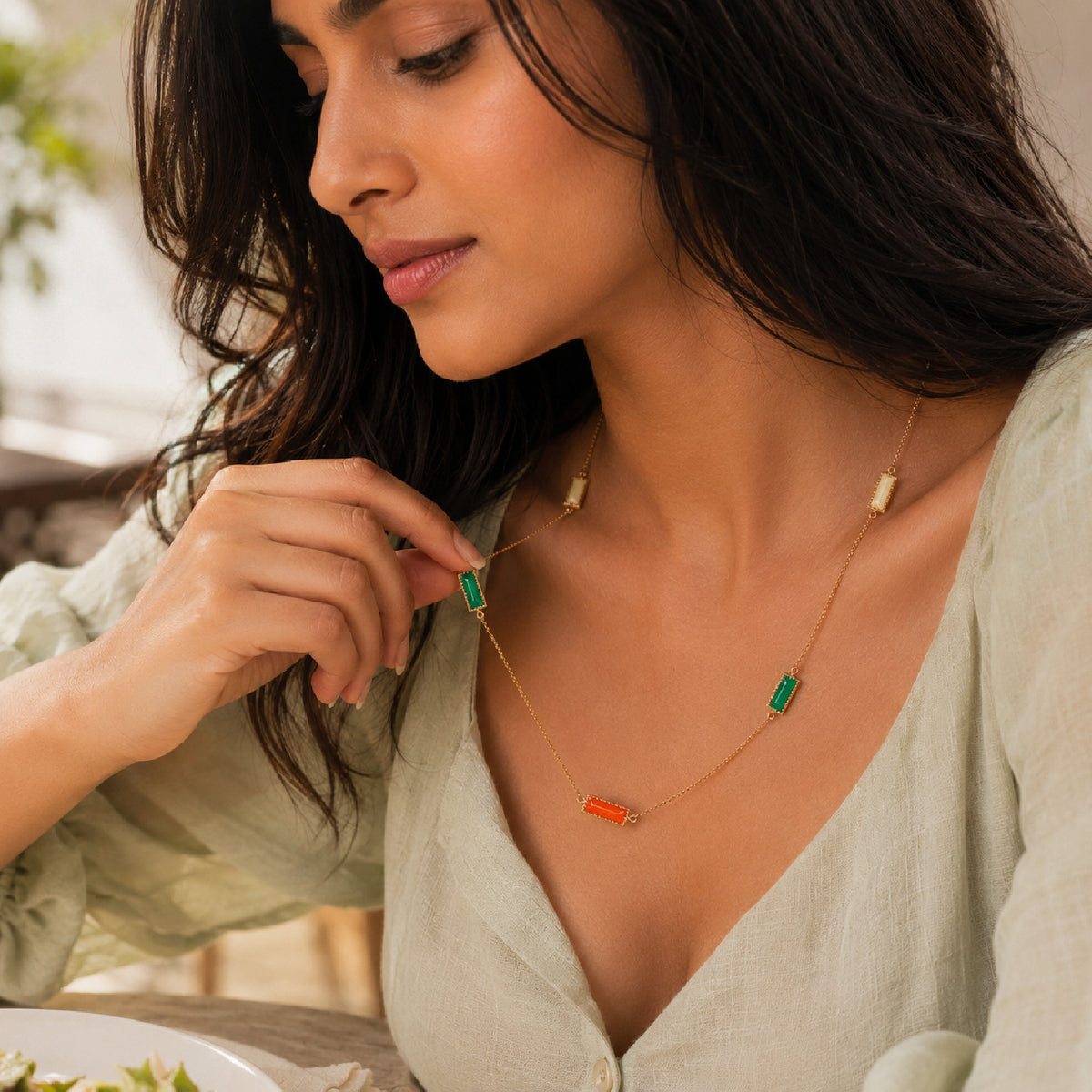 Deco Mosaic 18K gold-plated rectangular enamel pendant necklace in white, orange and green worn in a close-up lifestyle shot — Studio Anivarya